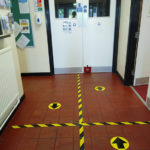 Entrance, with social distancing marks on the floor to ensure people remain the correct distance from each other.